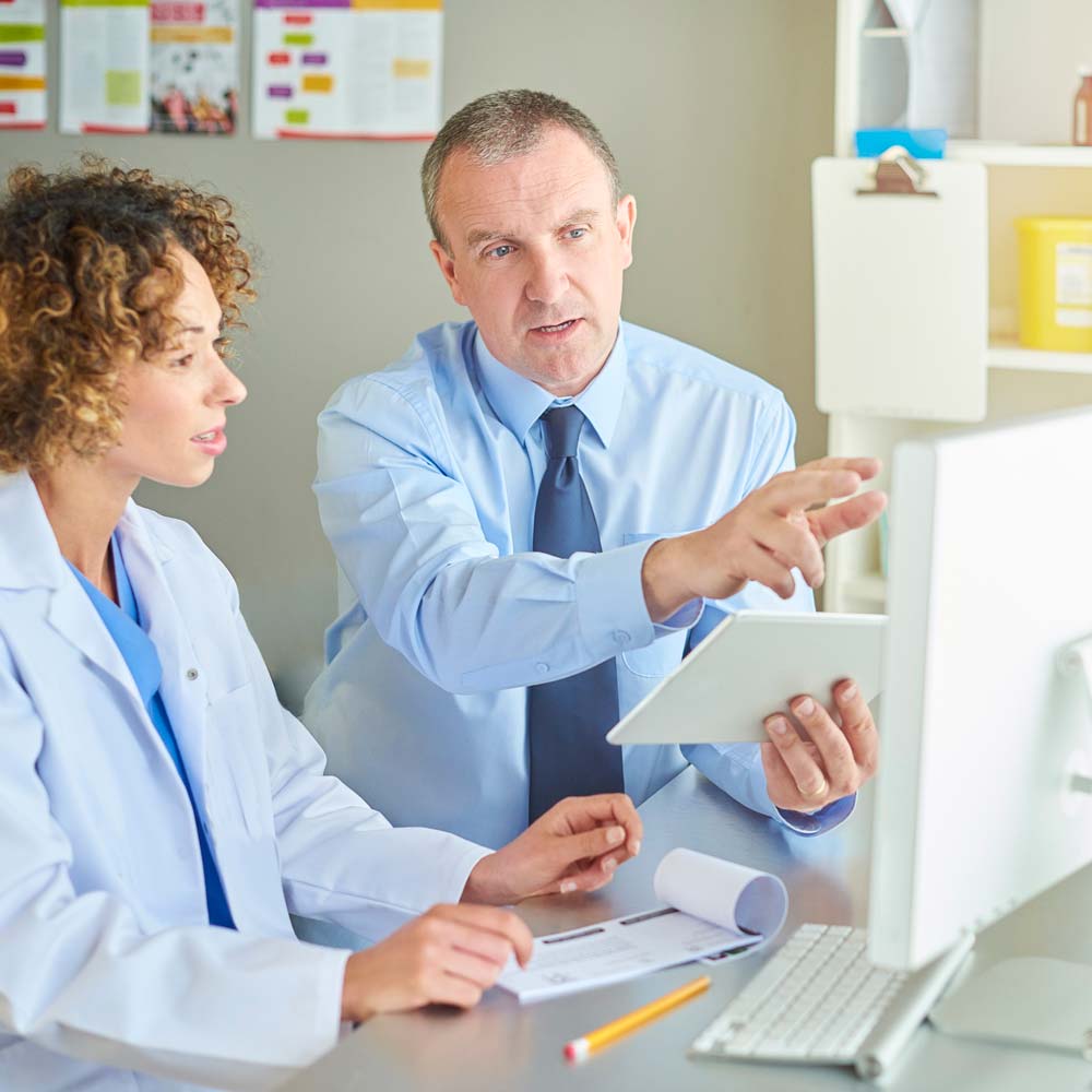 Dentist Talking With a Marketing Professional